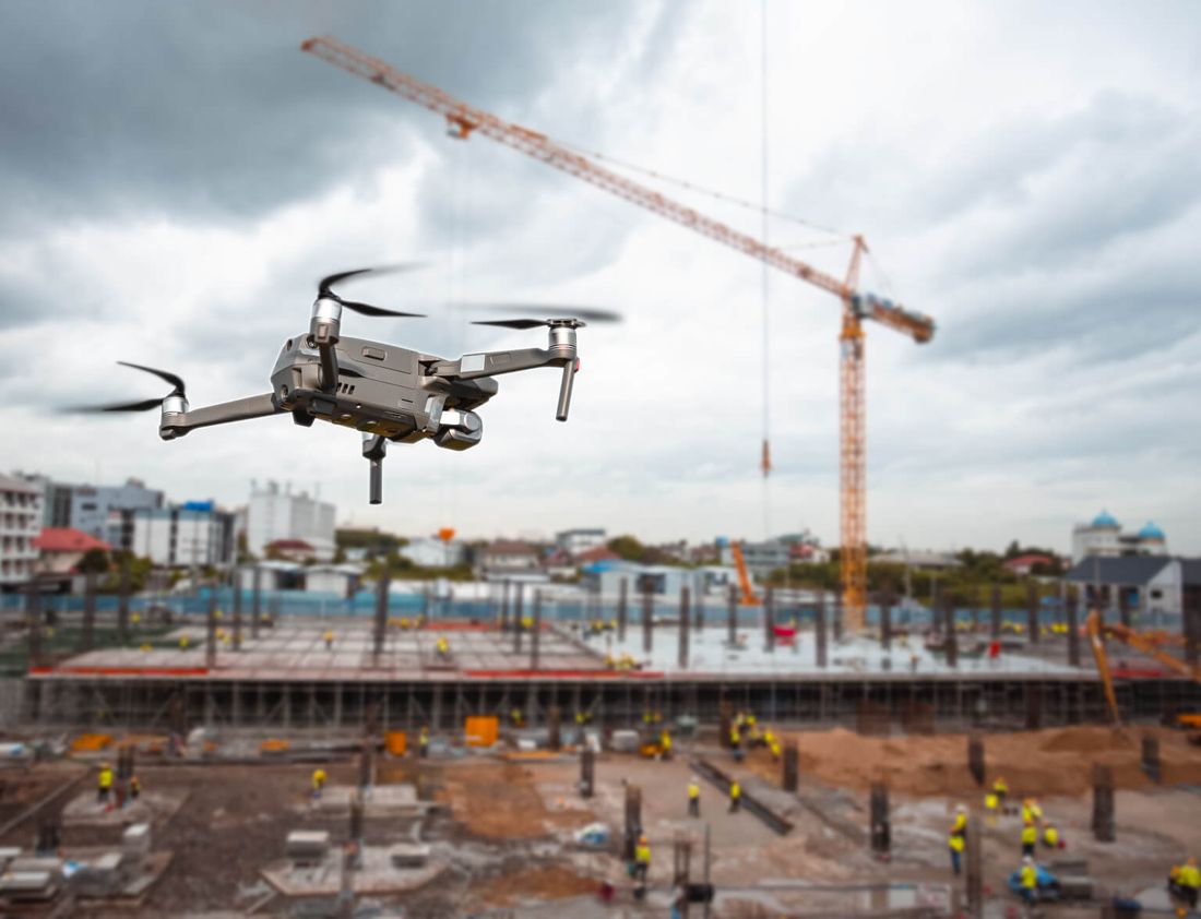 Survey drone flying over a construction site